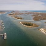 Aerial capture of serene waterway and marshlands near Wrightsville Beach, NC.