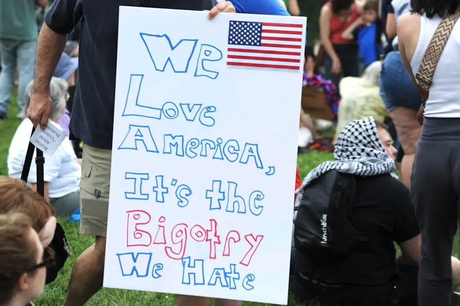 A peaceful protest sign advocating against bigotry in Baltimore park.